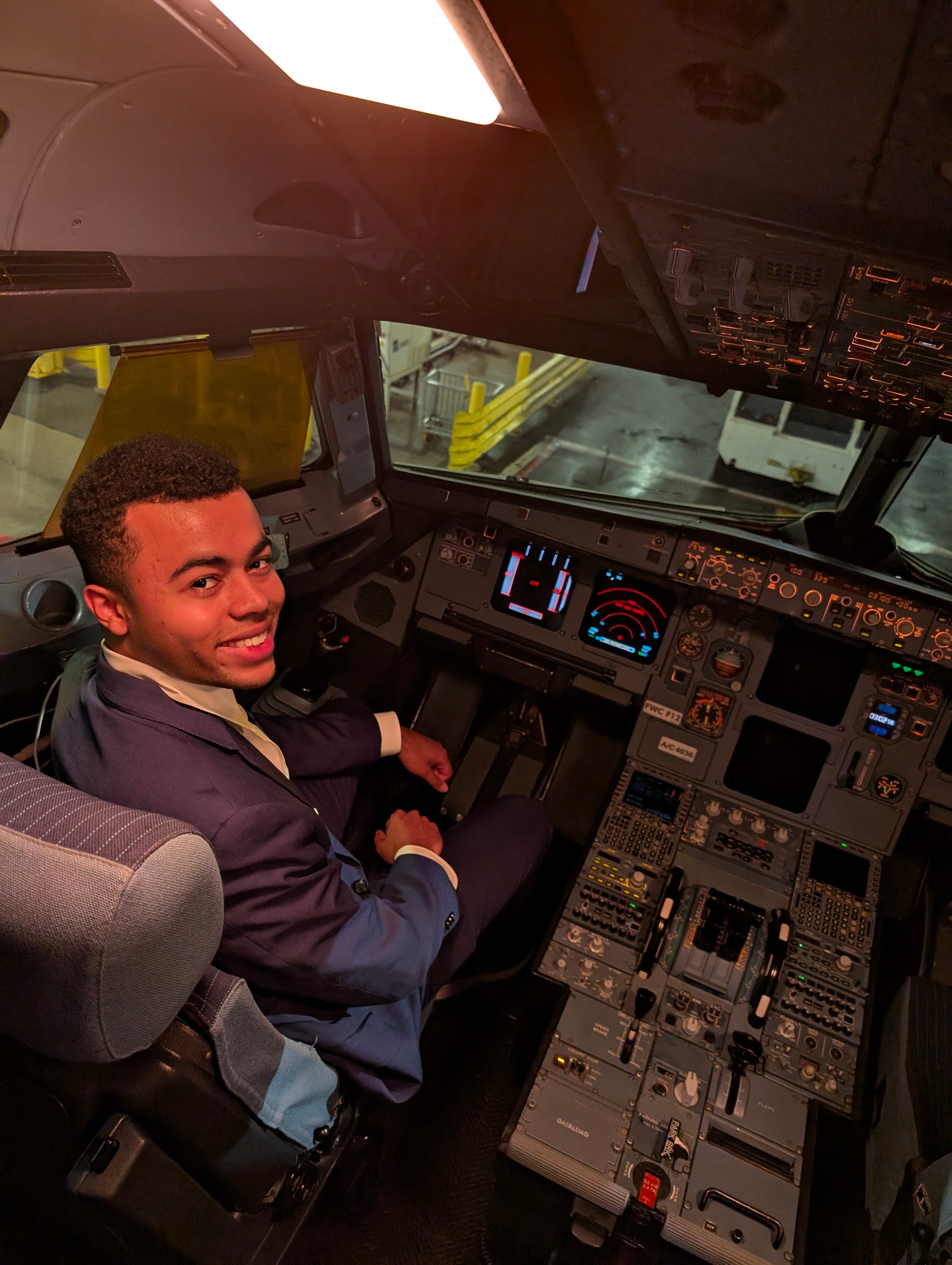 Ehab James sitting in an aircraft cockpit